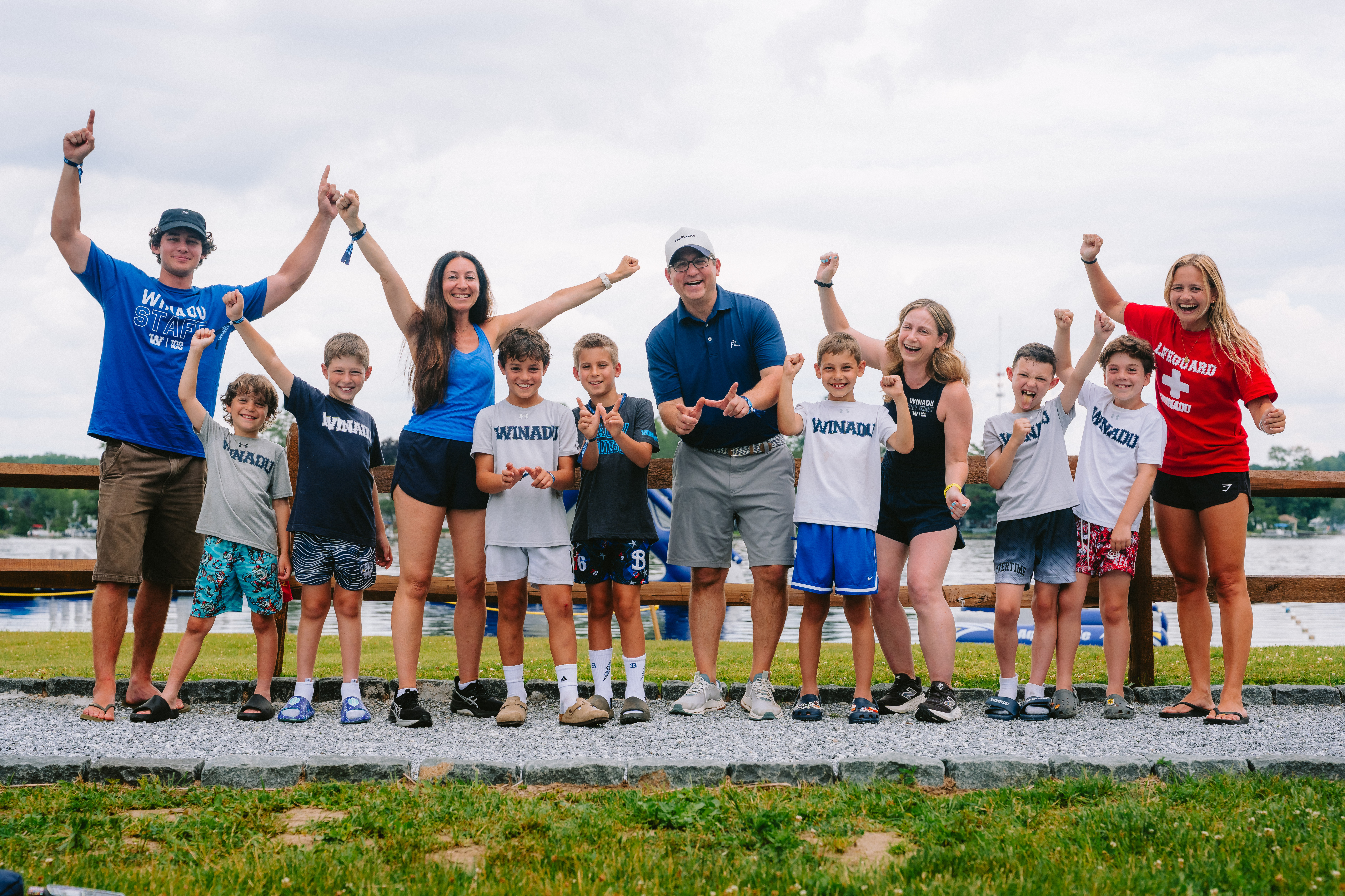 Camp Winadu staff and campers celebrating by the lake