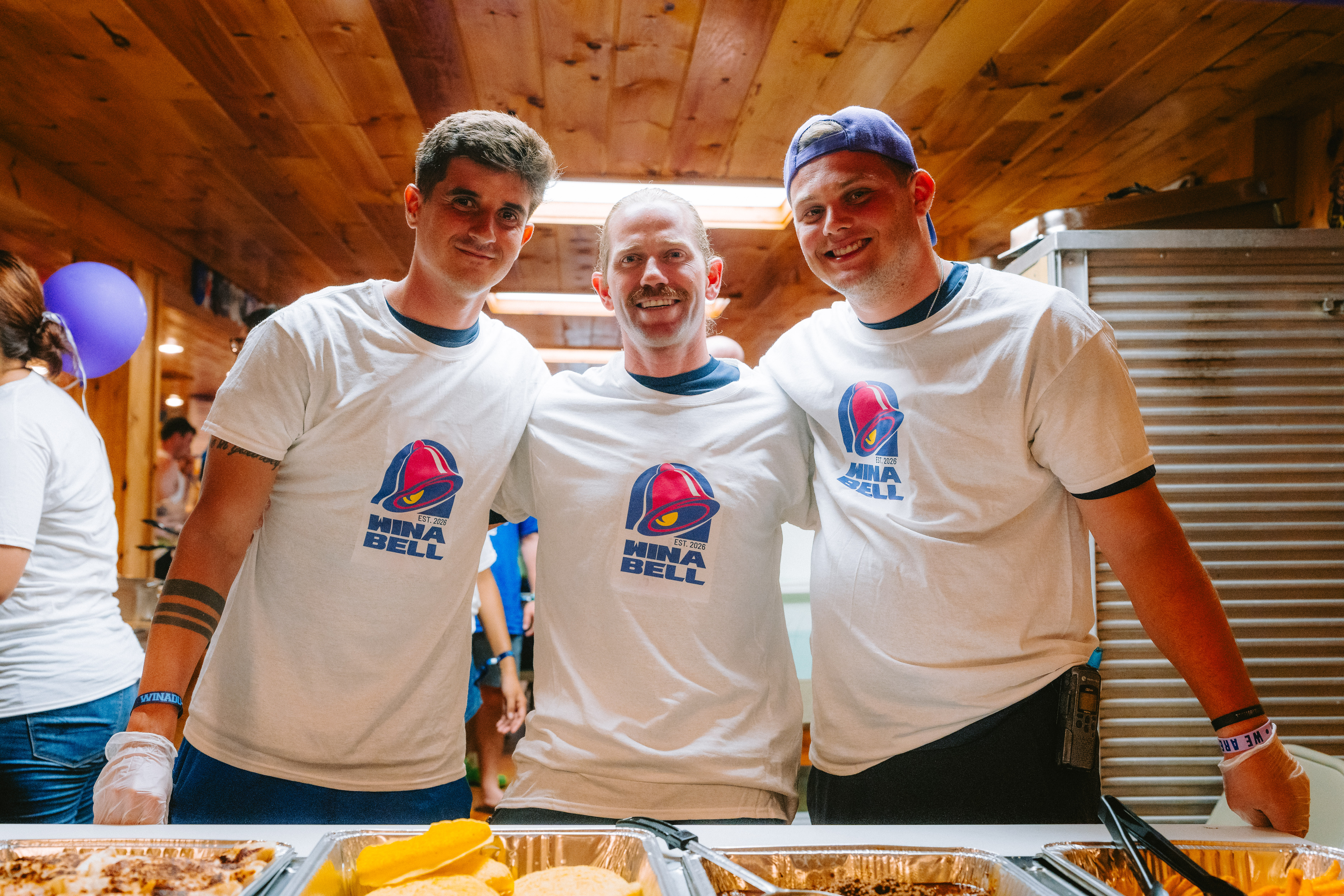 Camp Winadu support staff serving food in the dining hall