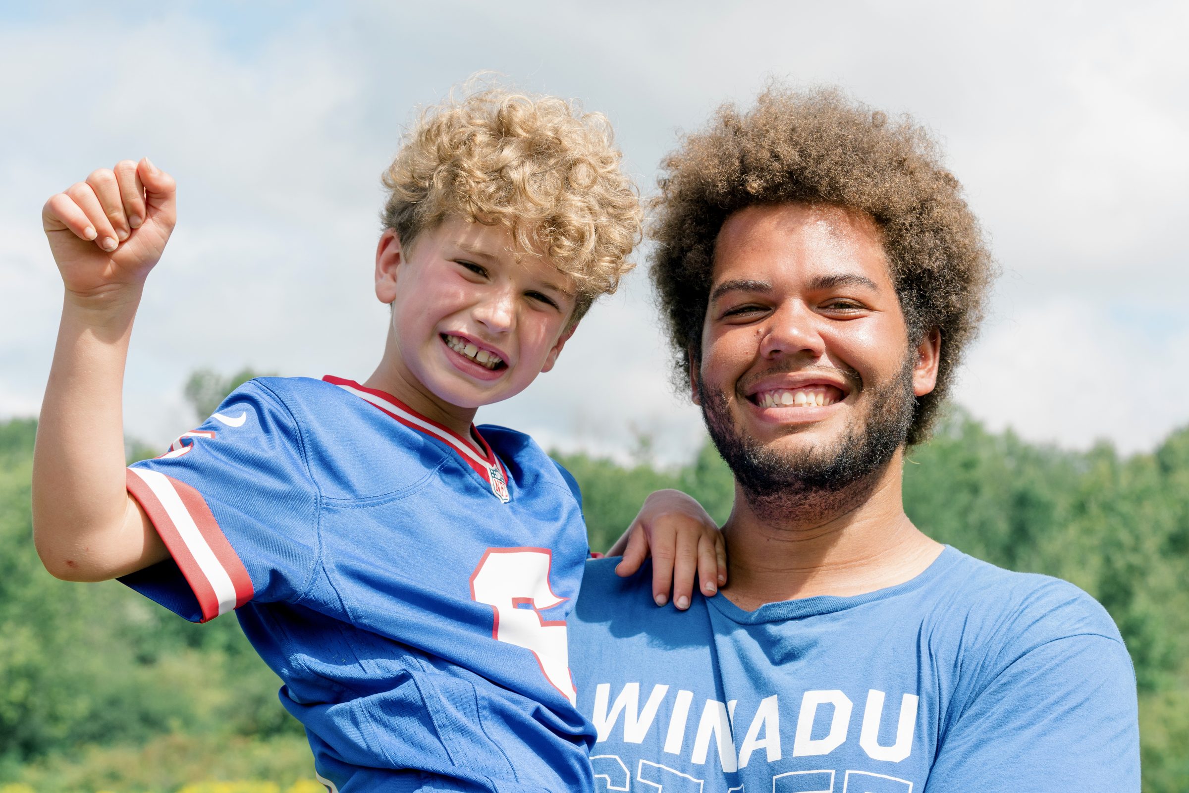 Camp Winadu counselor cheering with a camper