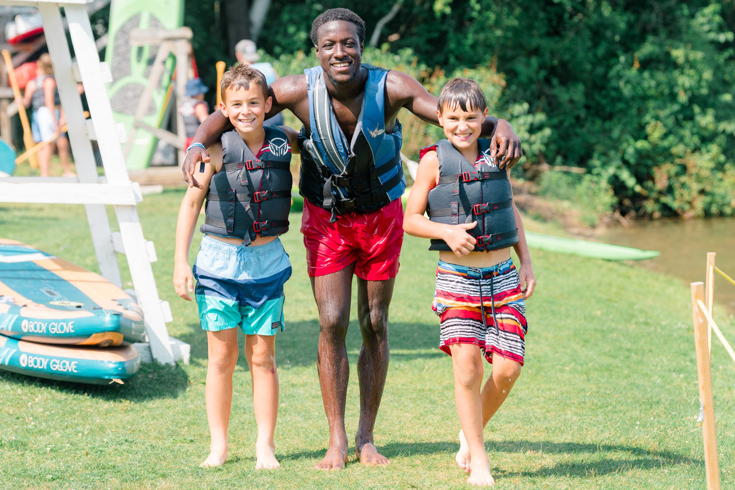 Camp Winadu counselor walking with campers in life jackets
