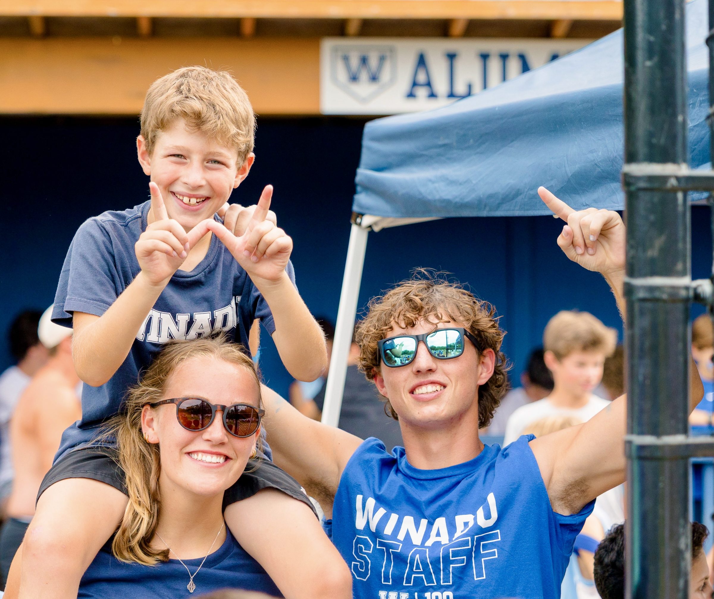 Camp Winadu counselors with a camper on their shoulders