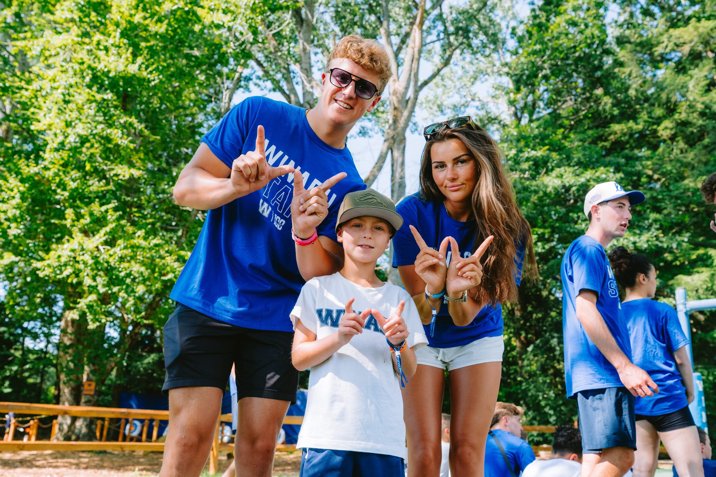 Two Camp Winadu staff in blue shirts with a camper