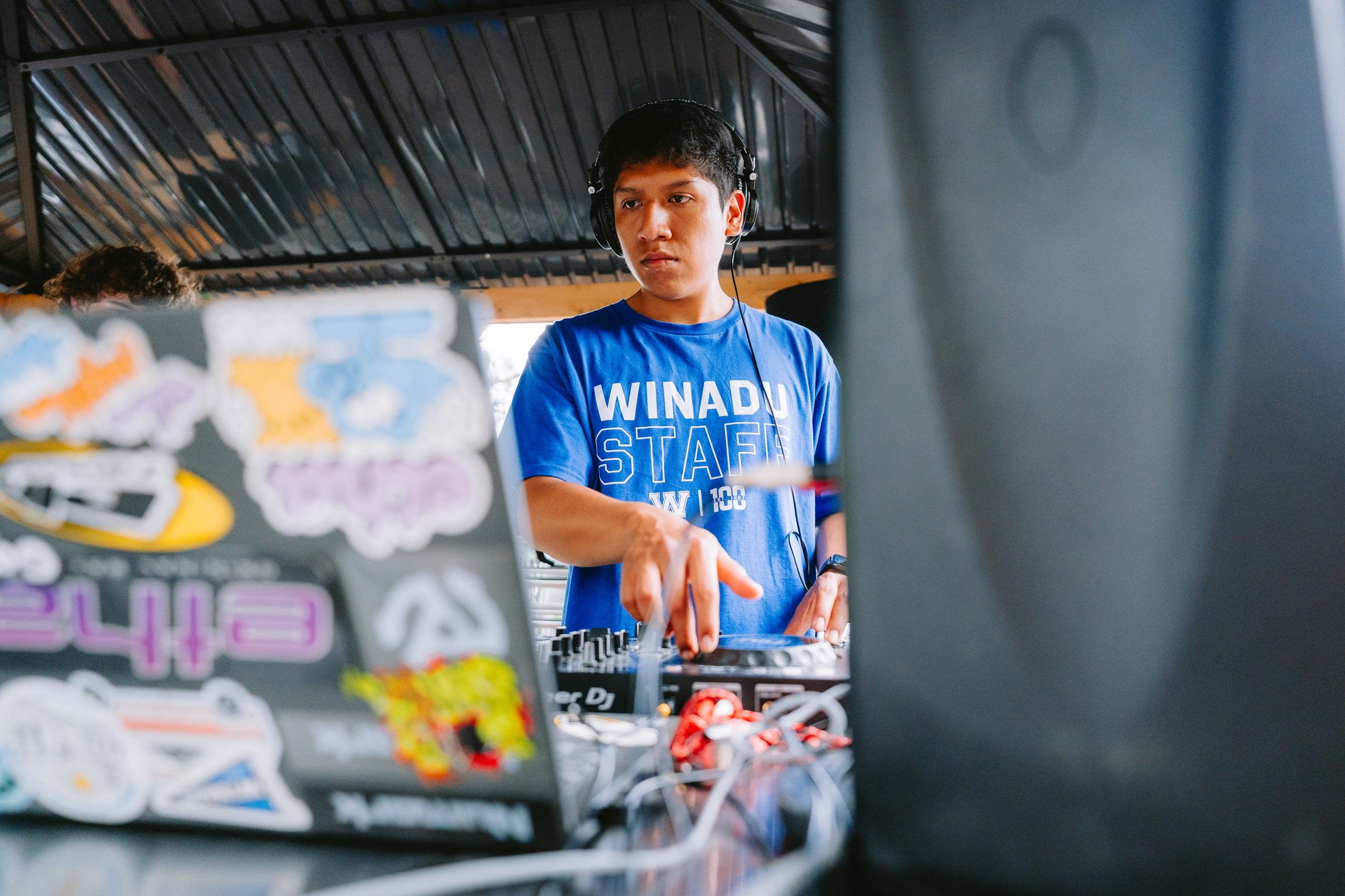 Camp Winadu DJ Instructor mixing at the DJ booth