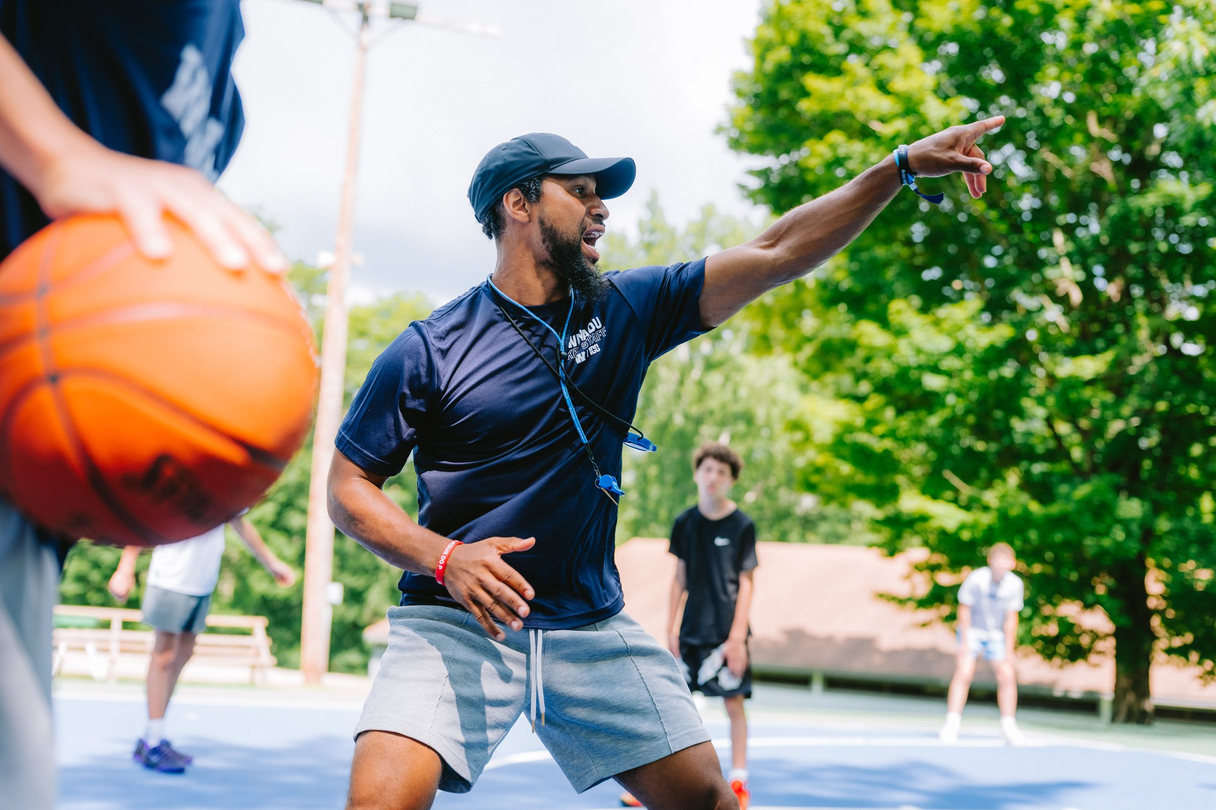 Camp Winadu basketball coach leading campers on the court