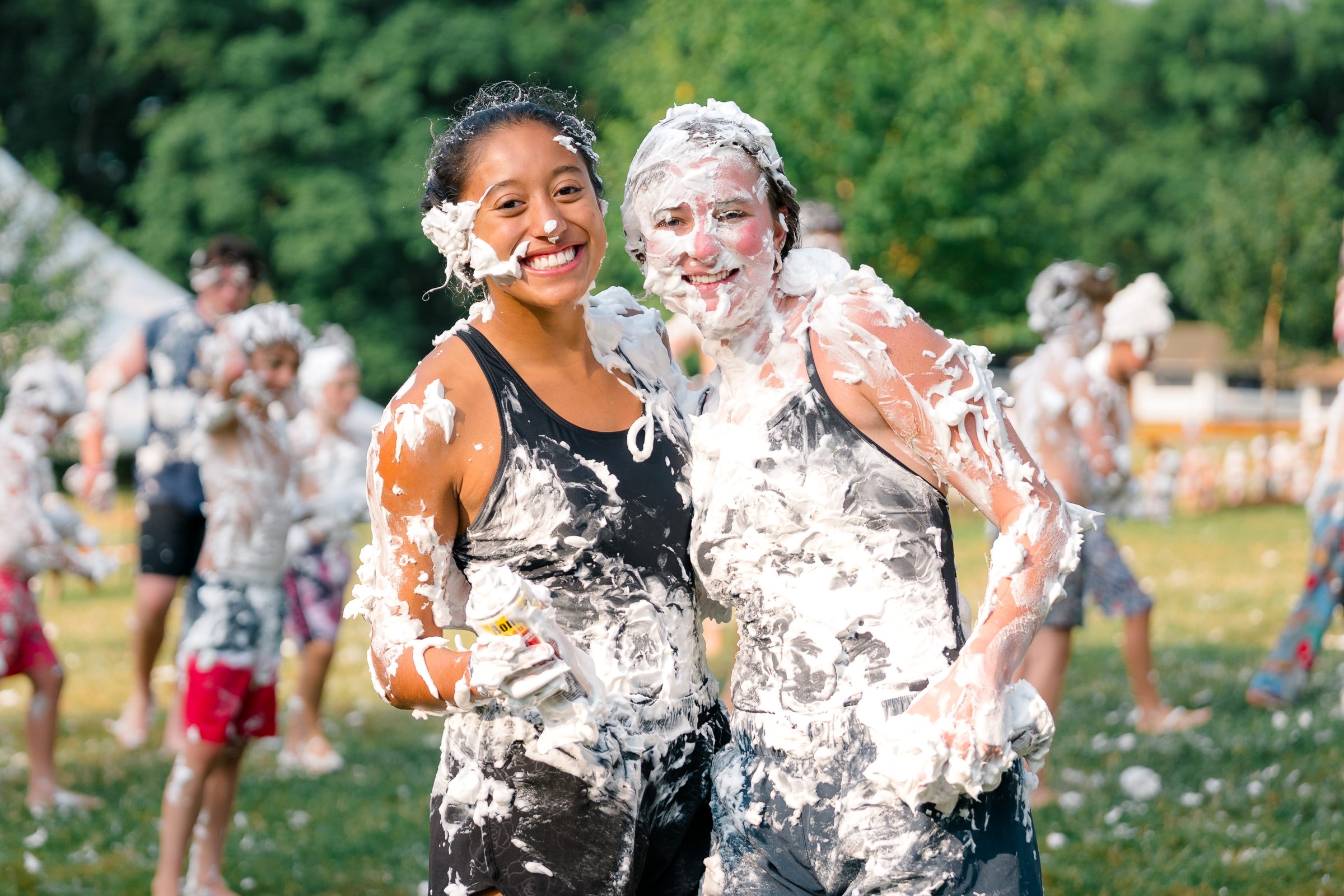 Counselors covered in shaving cream laughing together