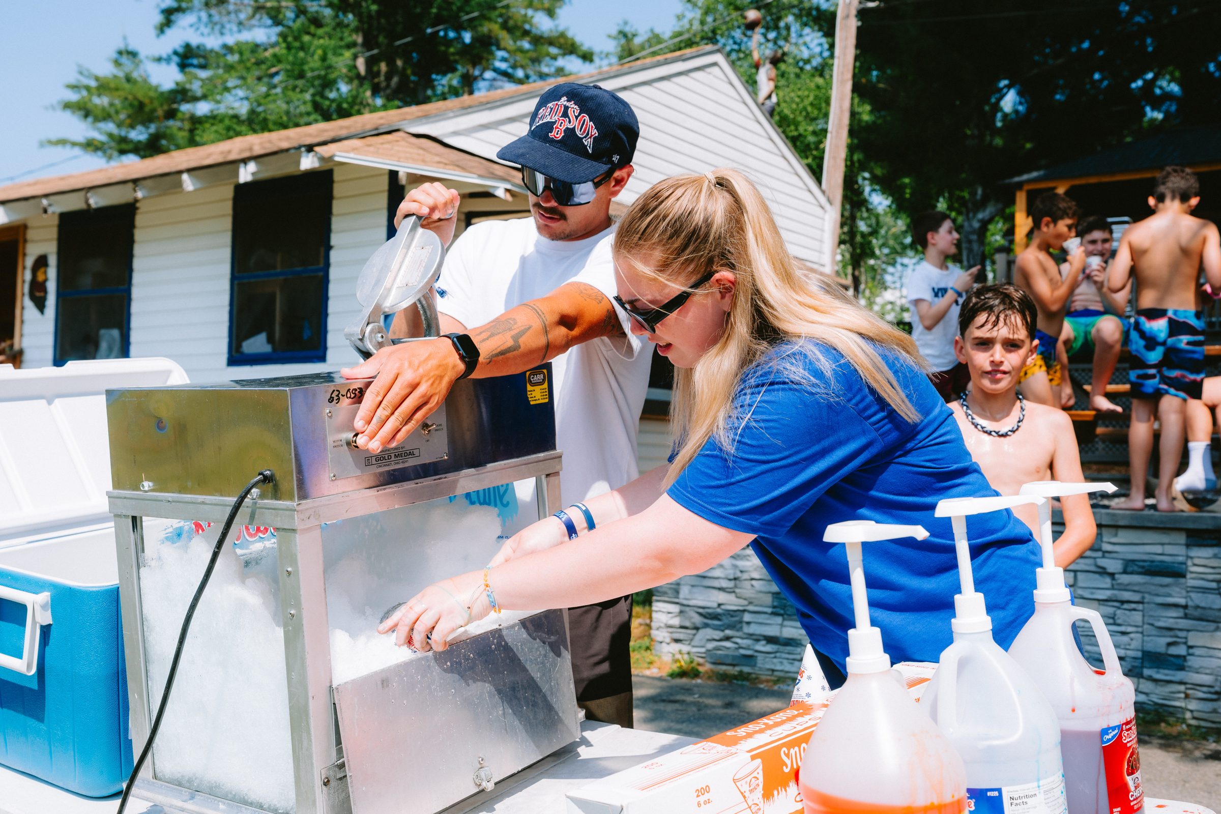 Camp Winadu support staff making snow cones for campers